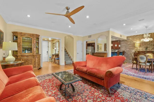a living room with furniture a rug and a large window