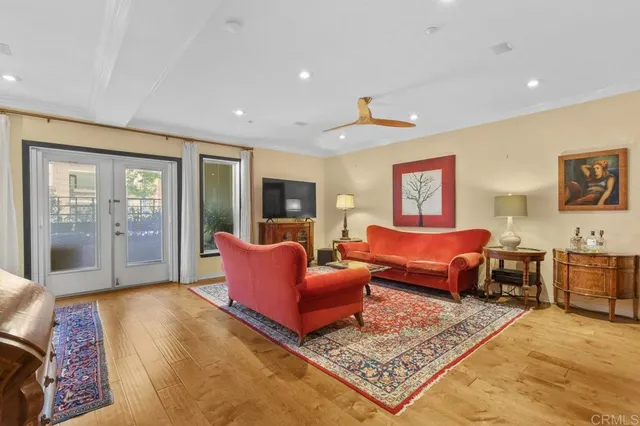 a living room with furniture rug and wooden floor