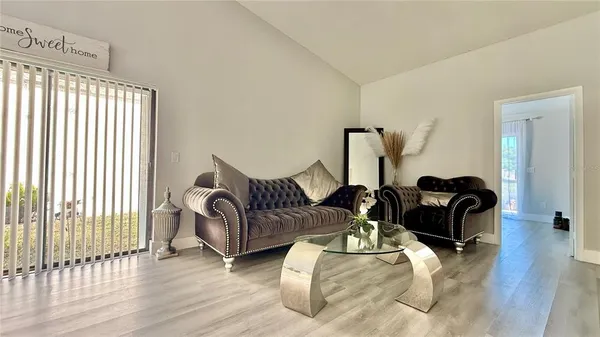 a living room with furniture and wooden floor