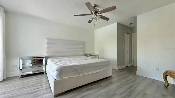 a bedroom with a bed and a chandelier