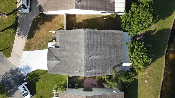 an aerial view of a house with a yard