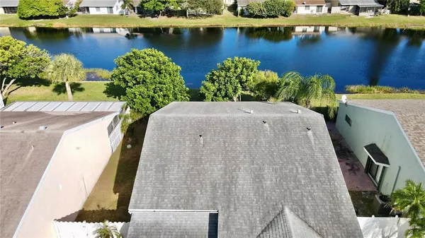 an aerial view of a house with a lake view