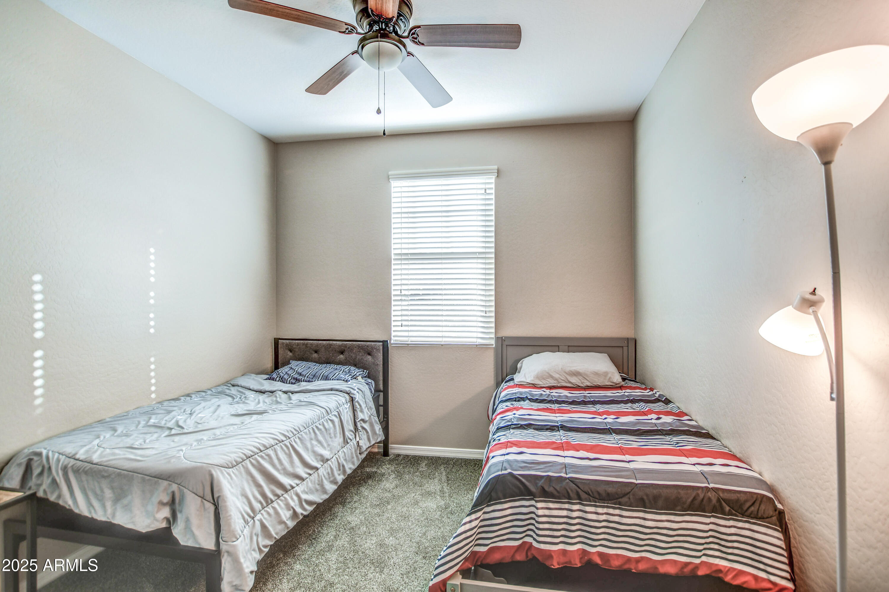 2842 East Fraktur Road Phoenix, AZ 85040 - Photo 12 of 46 a bedroom with double bed and a chandelier