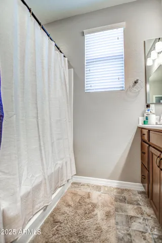 a bedroom with a bed and a ceiling fan