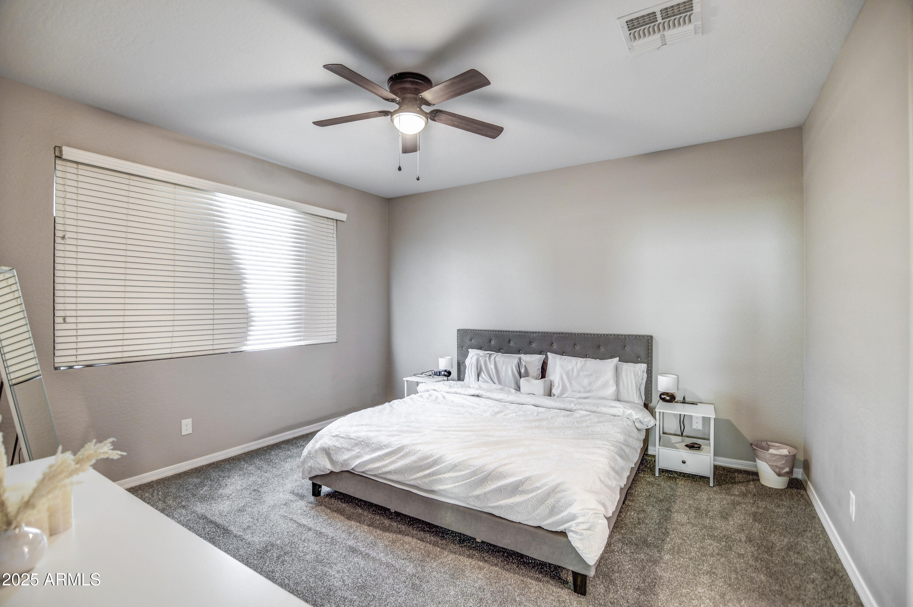 2842 East Fraktur Road Phoenix, AZ 85040 - Photo 25 of 46 a bedroom with a bed and a ceiling fan