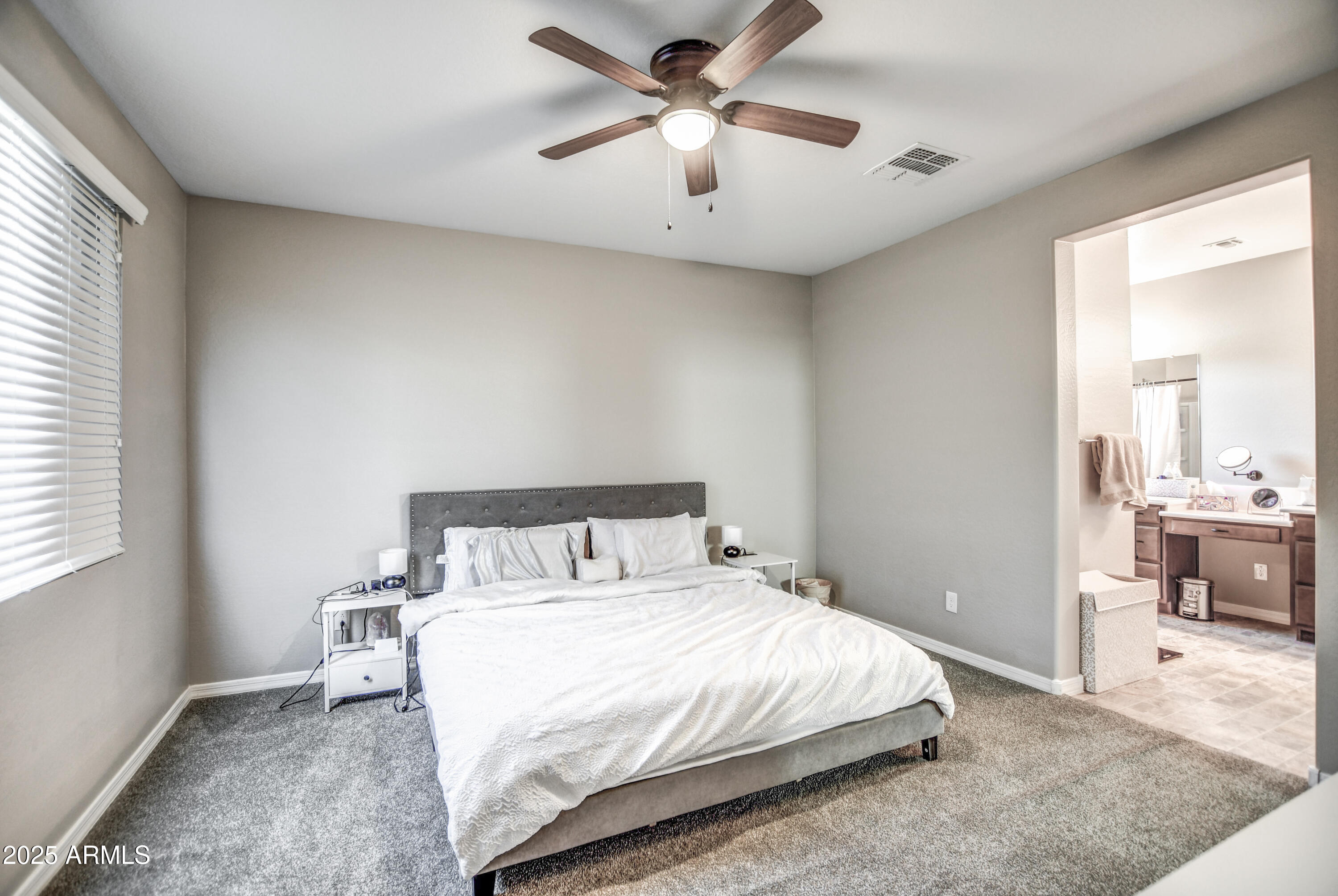 2842 East Fraktur Road Phoenix, AZ 85040 - Photo 26 of 46 a bedroom with a bed and a chandelier
