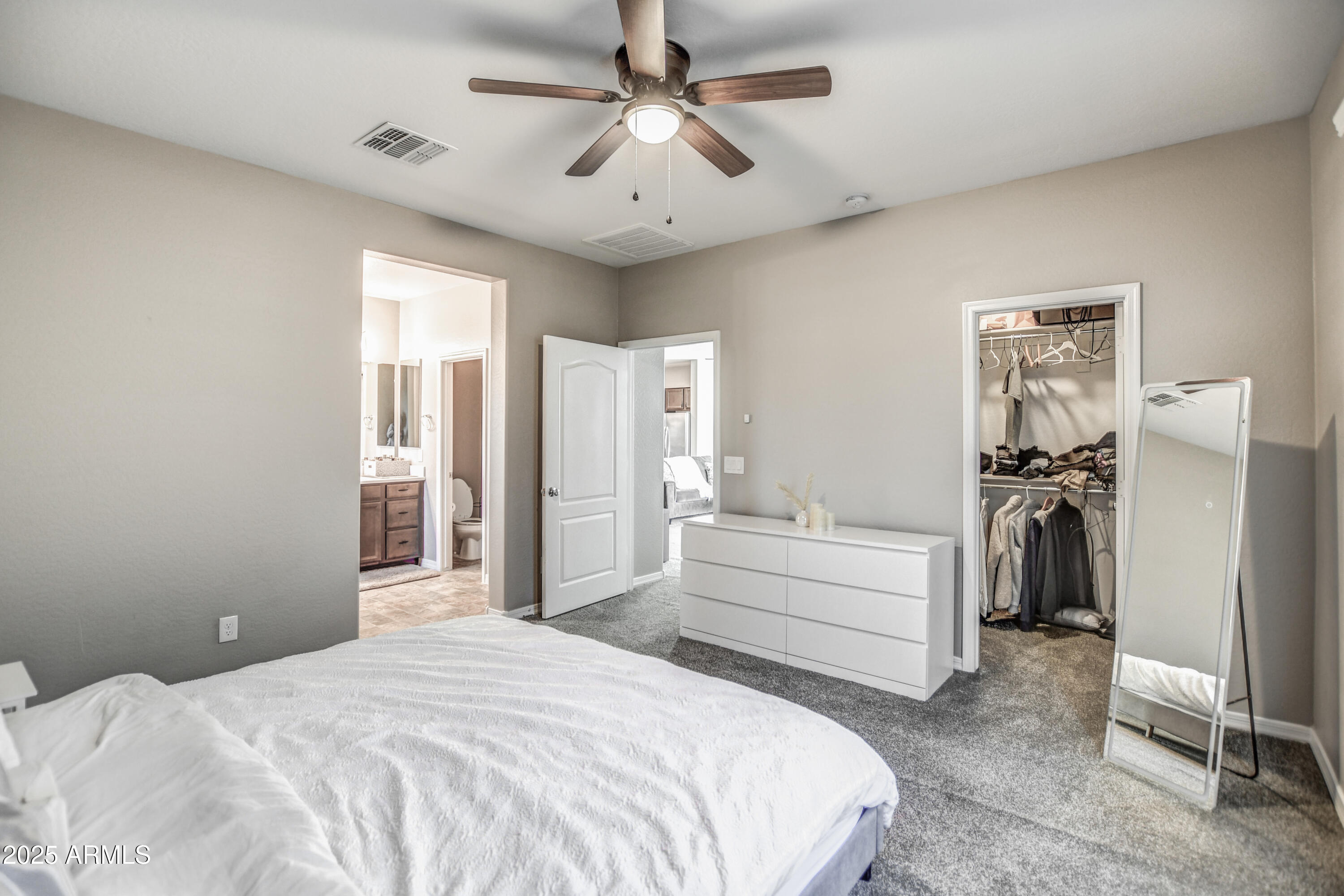 2842 East Fraktur Road Phoenix, AZ 85040 - Photo 27 of 46 a bedroom with a bed and a chandelier