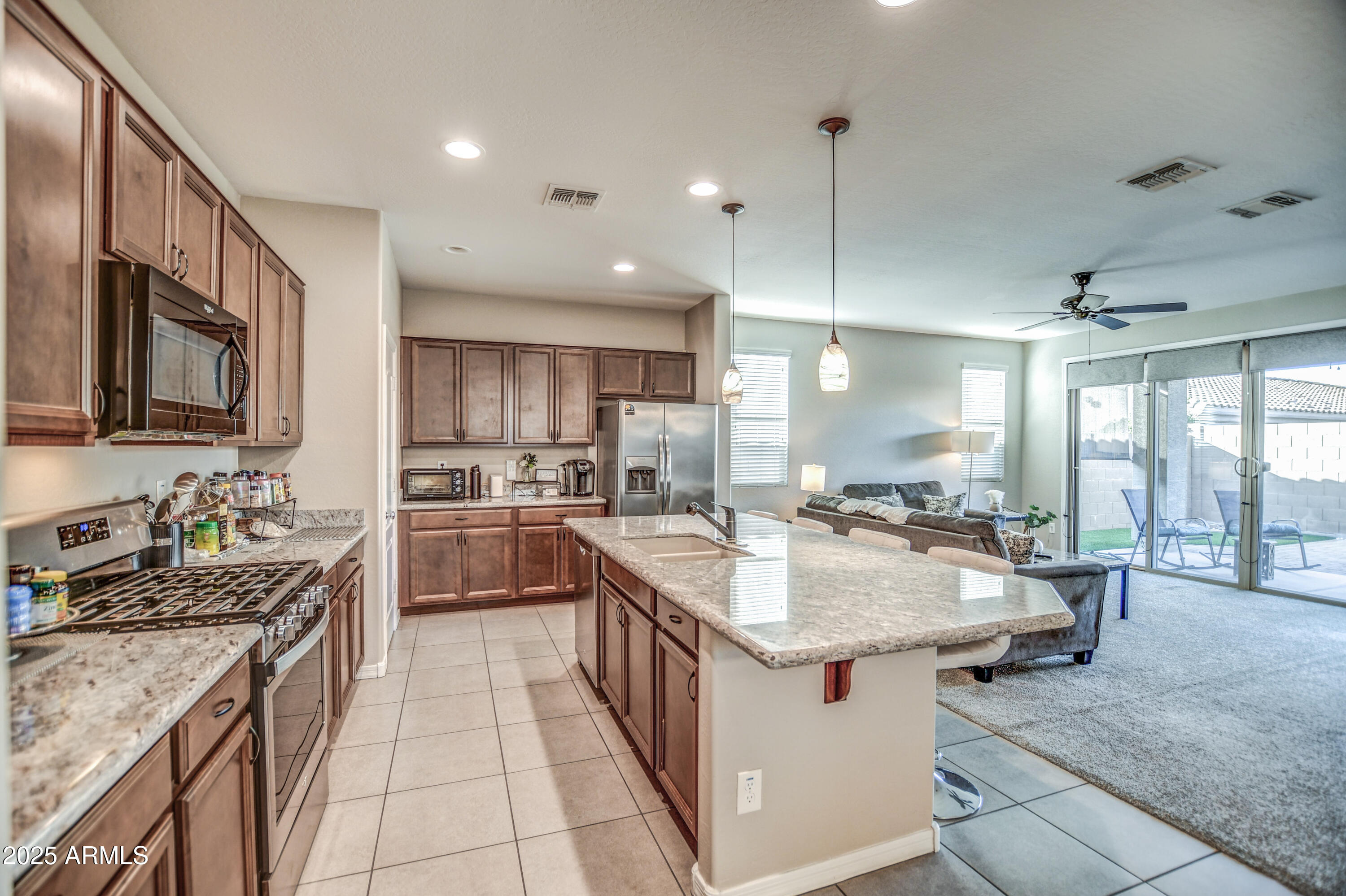 2842 East Fraktur Road Phoenix, AZ 85040 - Photo 29 of 46 a kitchen with counter top space a sink appliances and cabinets