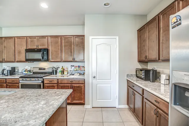 a kitchen with a sink a stove and cabinets
