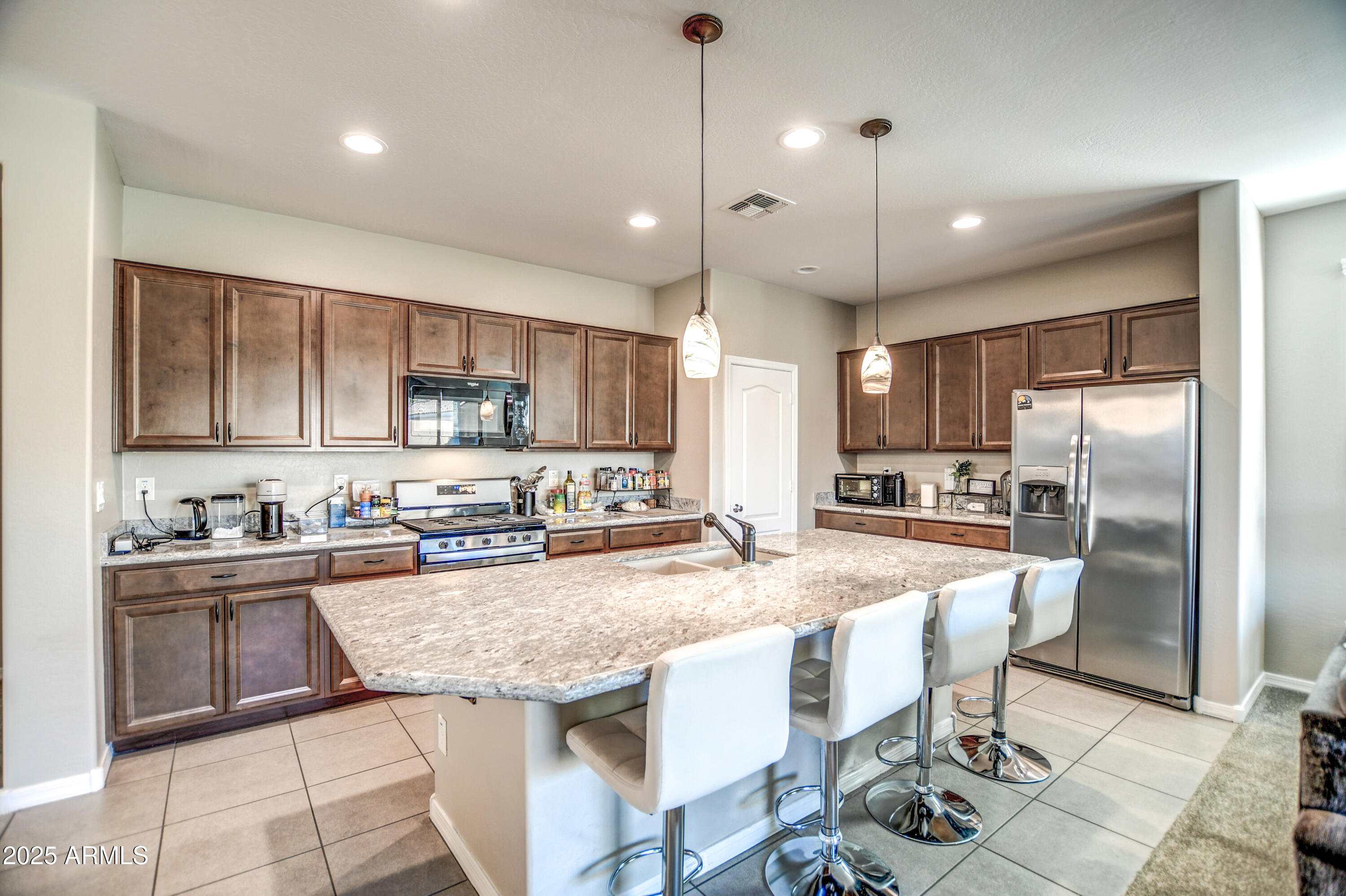2842 East Fraktur Road Phoenix, AZ 85040 - Photo 42 of 46 a kitchen with granite countertop a center island stainless steel appliances cabinets and a counter top space