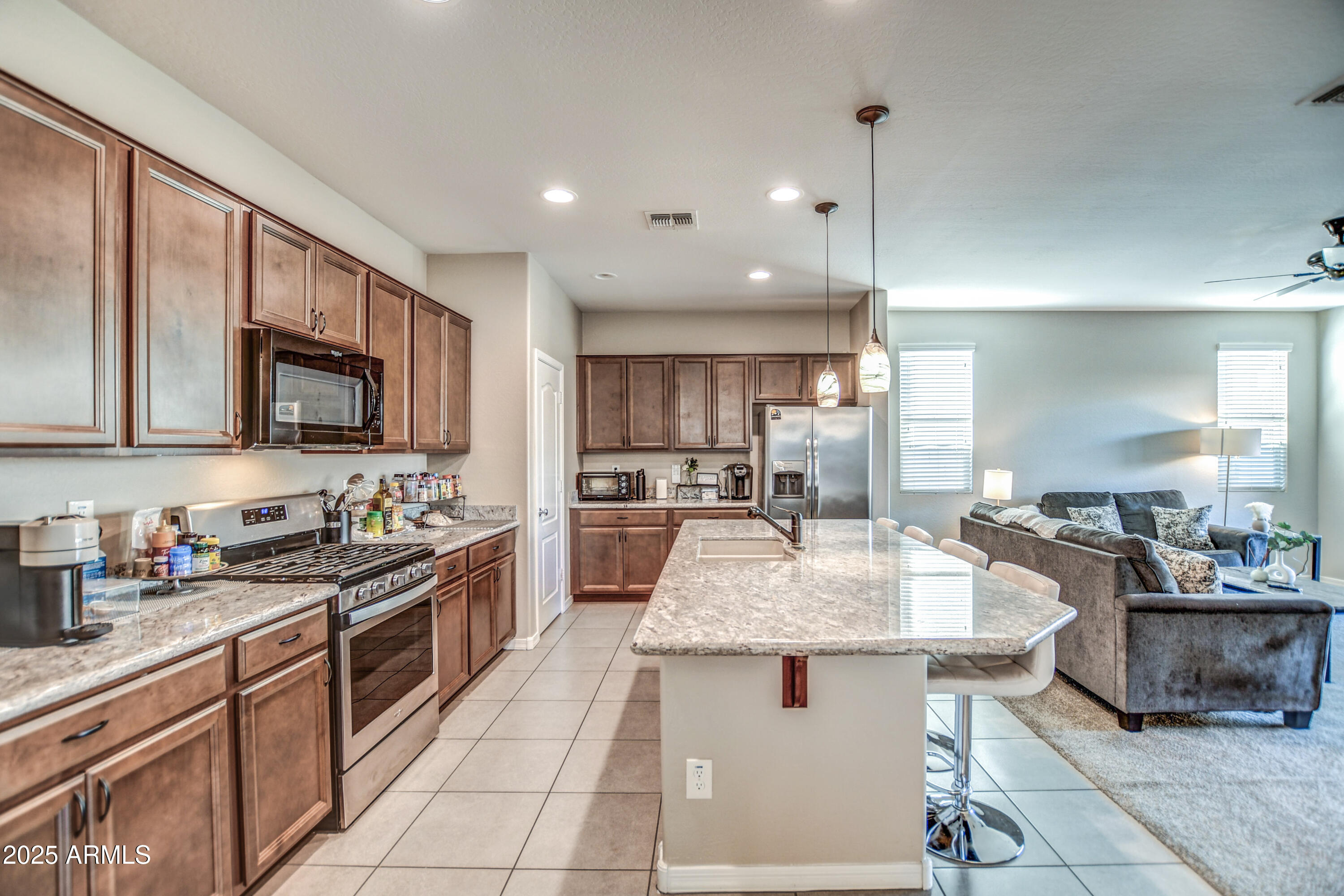 2842 East Fraktur Road Phoenix, AZ 85040 - Photo 44 of 46 a kitchen with stainless steel appliances granite countertop a sink stove and refrigerator