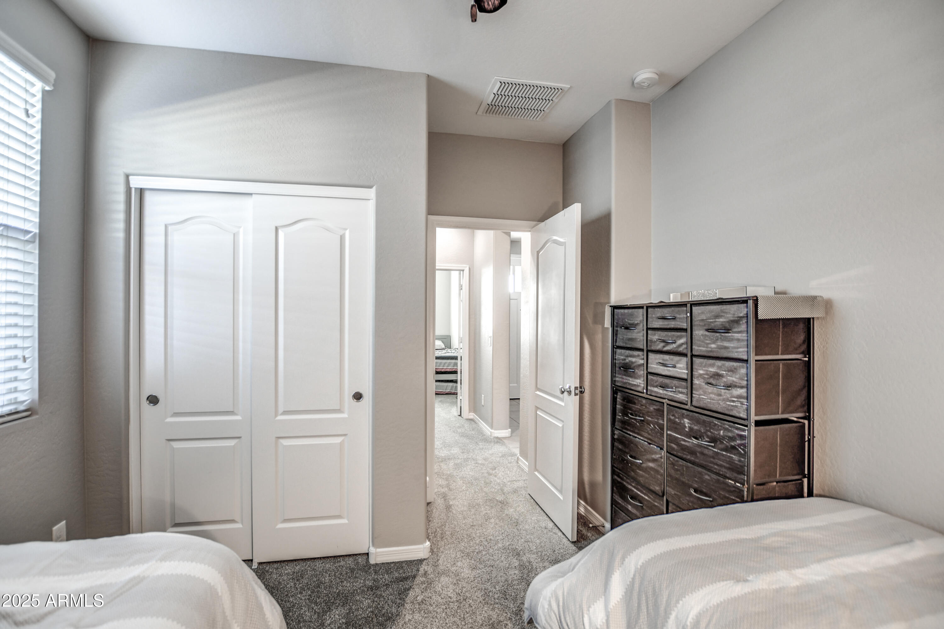 2842 East Fraktur Road Phoenix, AZ 85040 - Photo 5 of 46 a bedroom with a bed and a cabinet