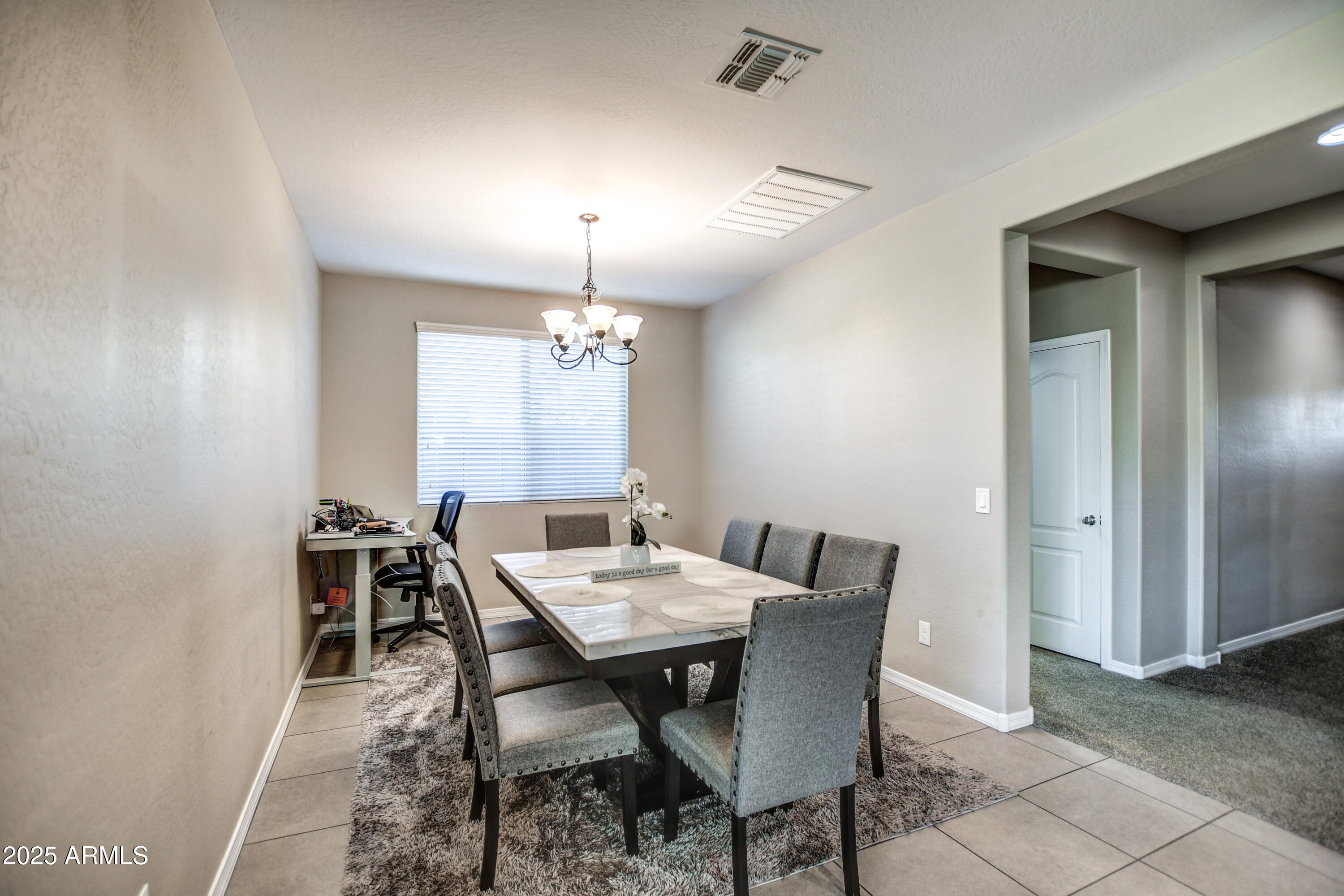 2842 East Fraktur Road Phoenix, AZ 85040 - Photo 7 of 46 a view of a dining room with furniture and chandelier