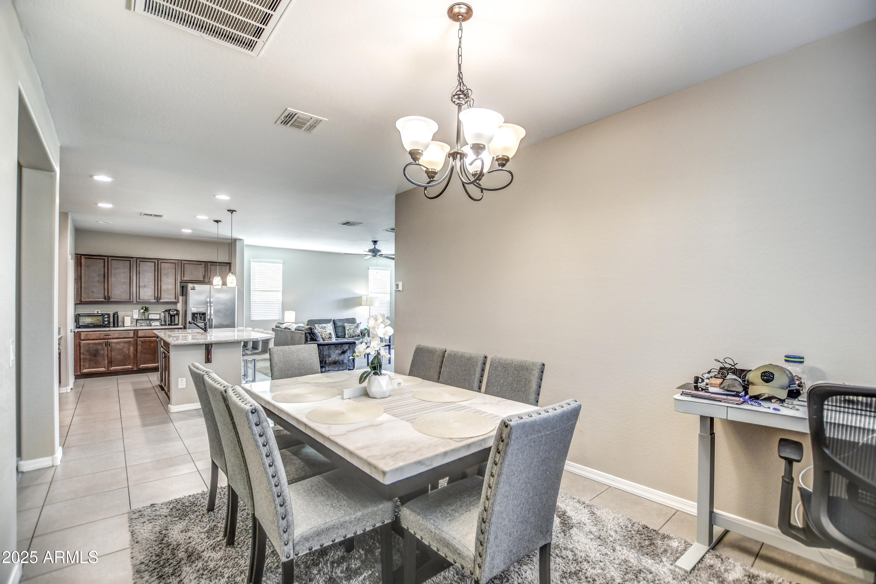 2842 East Fraktur Road Phoenix, AZ 85040 - Photo 8 of 46 a view of a dining room with furniture wooden floor and a chandelier
