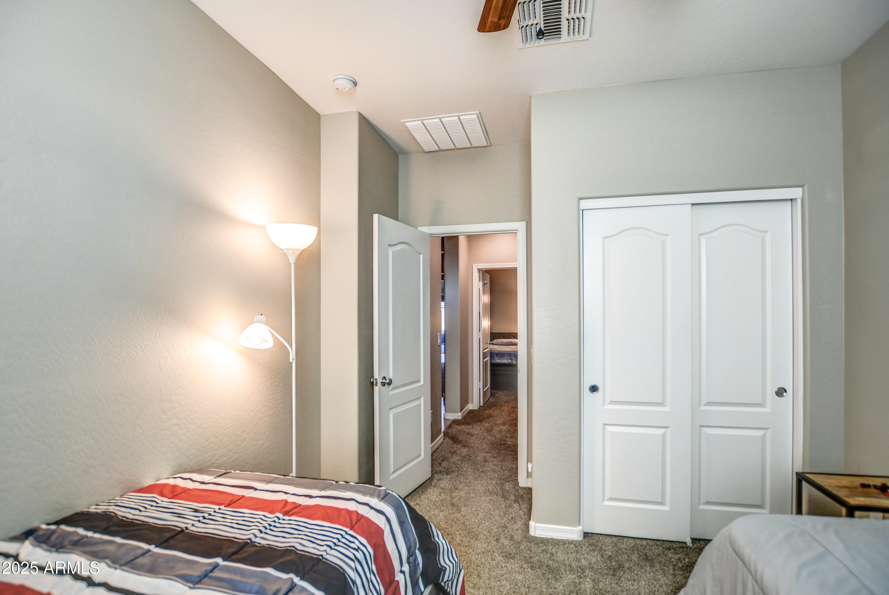 2842 East Fraktur Road Phoenix, AZ 85040 - Photo 9 of 46 a bedroom with a bed and a refrigerator