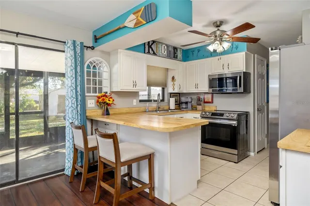 a kitchen with stainless steel appliances granite countertop a sink and a refrigerator