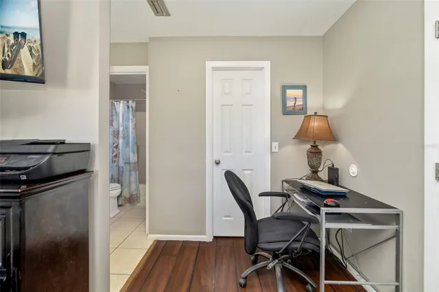 a work room with furniture and wooden floor