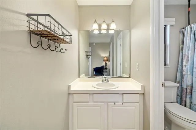 a bathroom with a sink a light fixture and a mirror