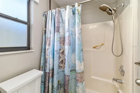 a bathroom with a shower and a toilet