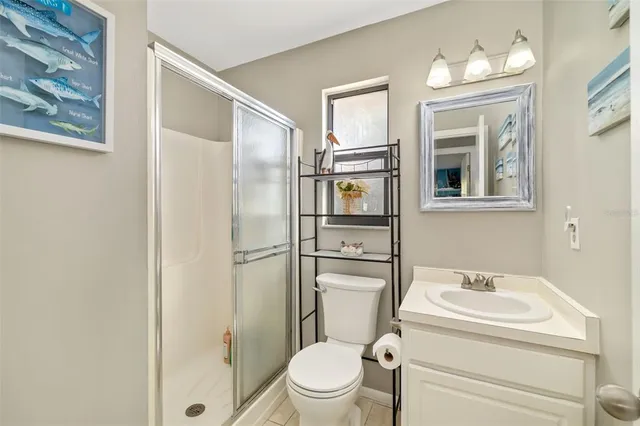 a white toilet sitting next to a bathroom sink