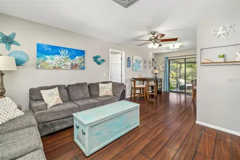 a living room with furniture dining table and wooden floor