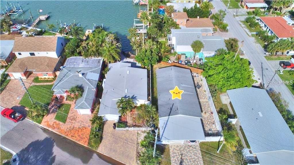 an aerial view of a house with a swimming pool and a yard