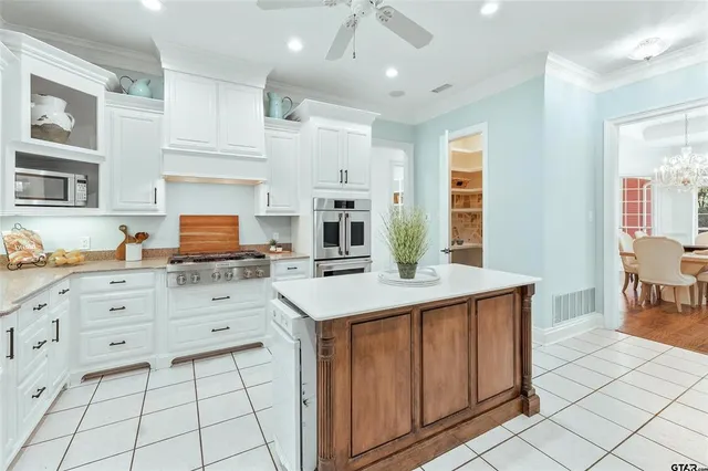 a kitchen with cabinets and window