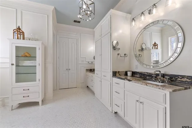 a bathroom with a double vanity sink mirror and bathtub