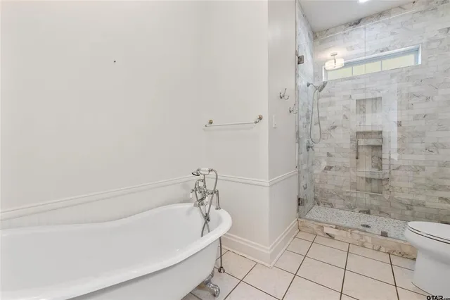 a bathroom with a bathtub and toilet