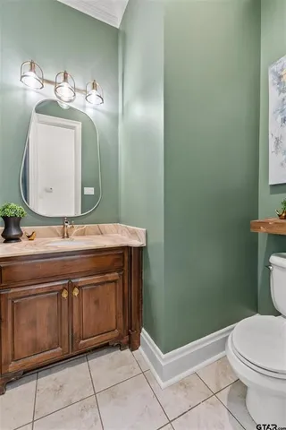a bathroom with a sink a toilet and mirror