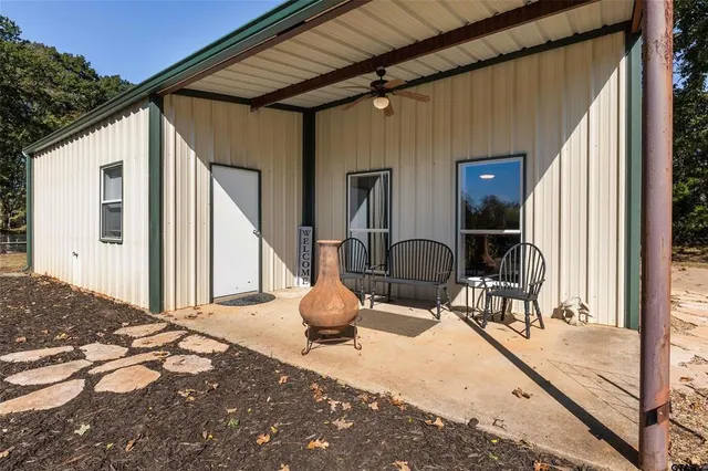 a view of a porch with furniture and floor to ceiling window