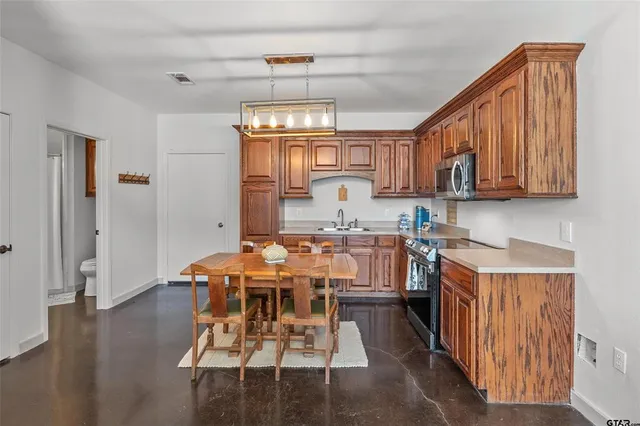 a view of a kitchen with dining table and chairs