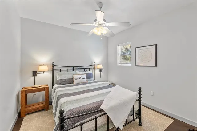 a bedroom with a bed and a chandelier