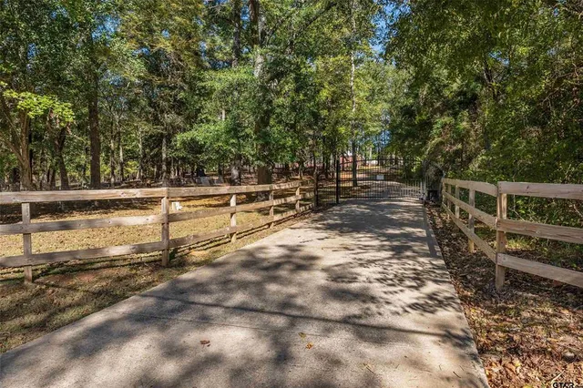 a view of a yard with wooden fence