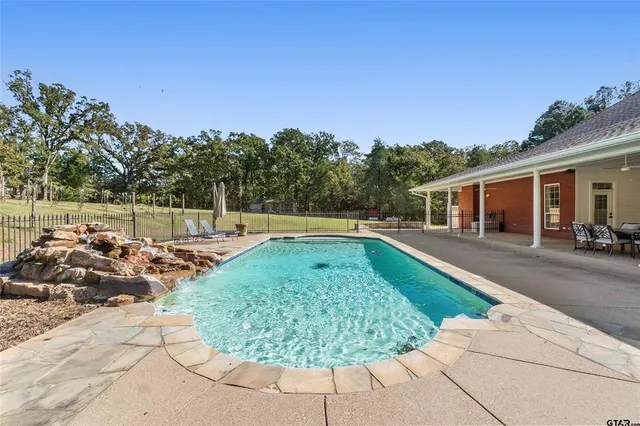 a view of a swimming pool with a patio