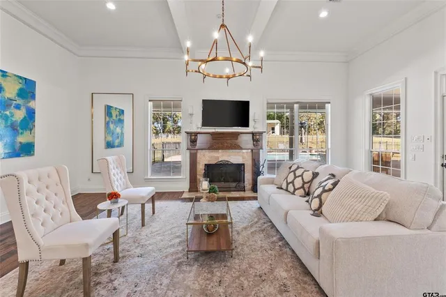 a living room with furniture a fireplace and a flat screen tv