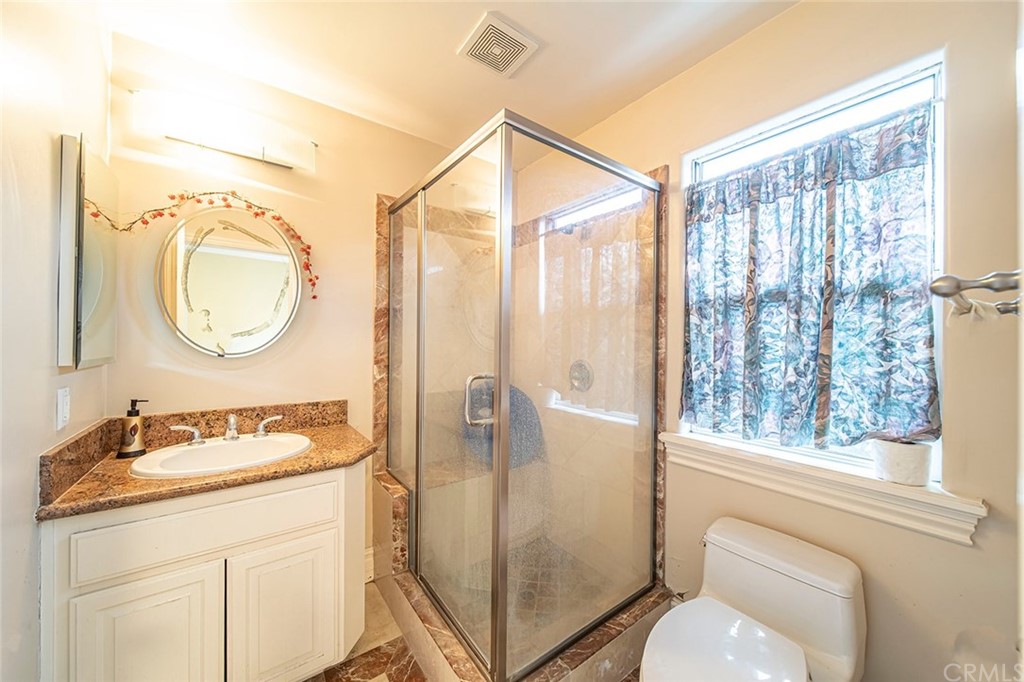 5237 Temple City Boulevard Temple City, CA 91780 - Photo 11 of 23 a bathroom with a granite countertop sink mirror vanity and a shower