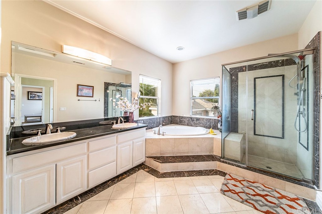 5237 Temple City Boulevard Temple City, CA 91780 - Photo 16 of 23 a spacious bathroom with a granite countertop tub sink and mirror