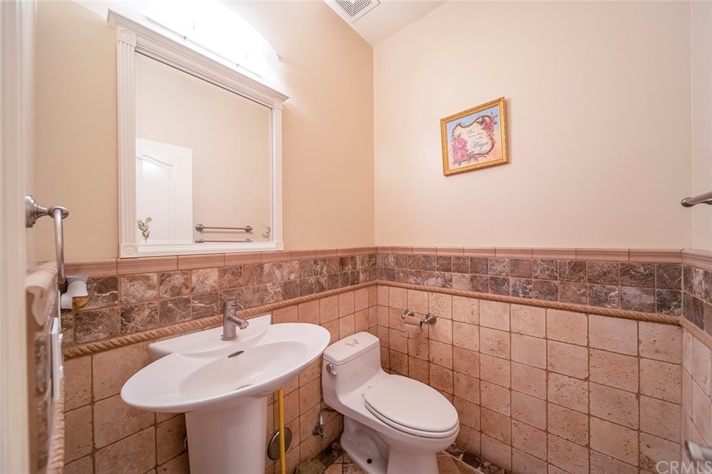 5237 Temple City Boulevard Temple City, CA 91780 - Photo 9 of 23 a bathroom with a toilet a sink and mirror