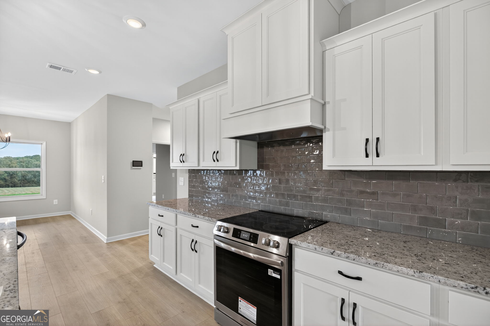 359 Gray Road Roopville, GA 30170 - Photo 21 of 46 a kitchen with granite countertop white cabinets and white appliances