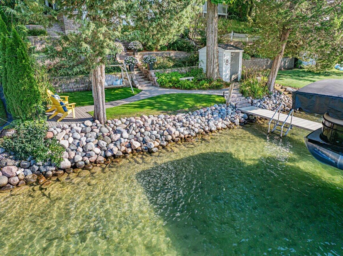 4763 Fontana Beach Road Polk, WI 53086 - Photo 7 of 61 Crystal Clear, sandy frontage. Perfectly sloped at the end of the pier. Keeping the little lake lovers safe while still being deep enough to dive off the pier!