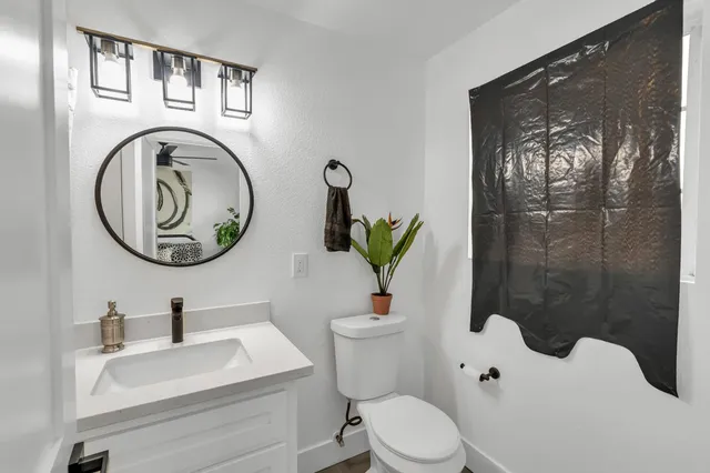 a large kitchen with hardwood floor and a sink