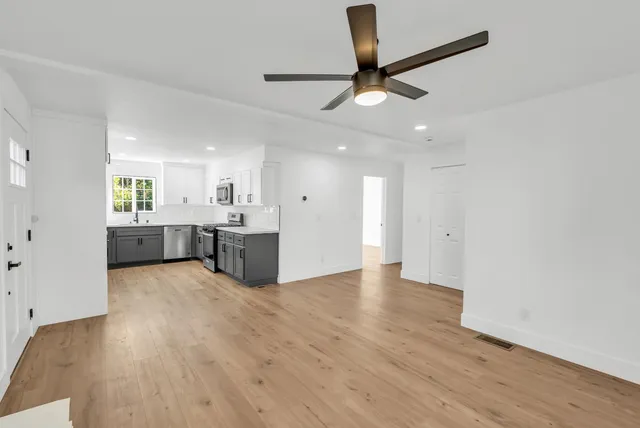 wooden floor in an empty room with a window