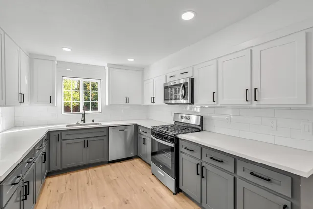a kitchen with a sink stove and cabinets