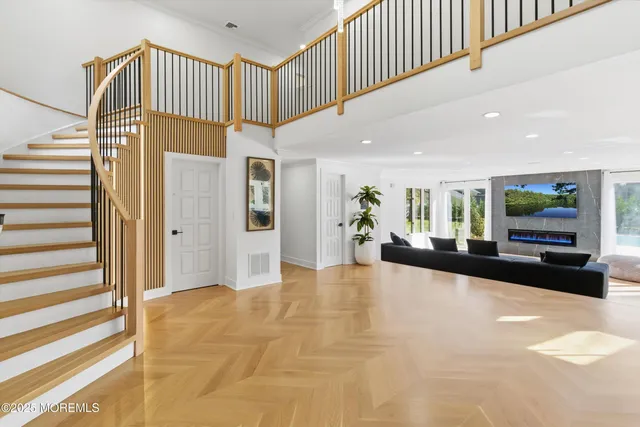 a view of a hallway with entryway and livingroom with furniture