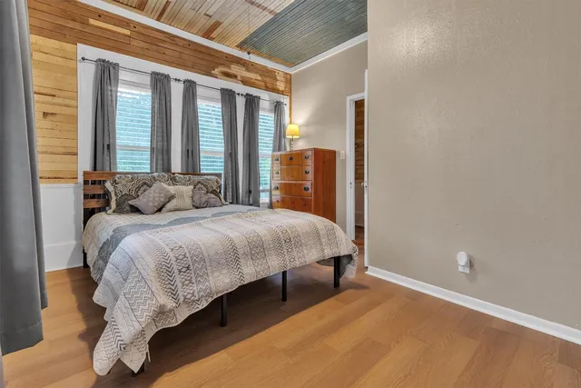 a bedroom with a bed and a large window