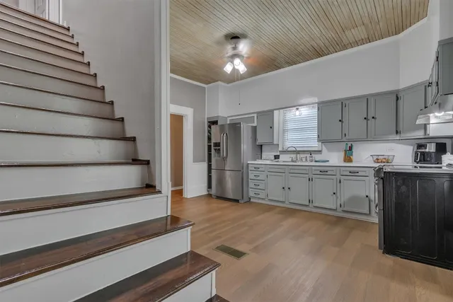 a kitchen with cabinets and a stove top oven