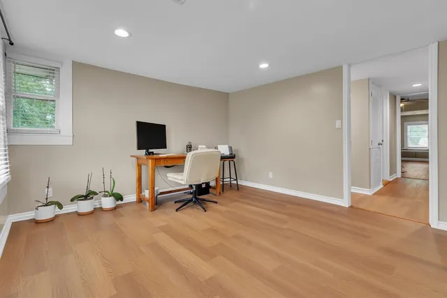 a view of a workspace with furniture and a window