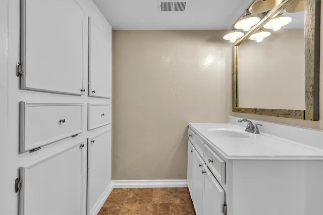 a bathroom with a sink a vanity and a mirror