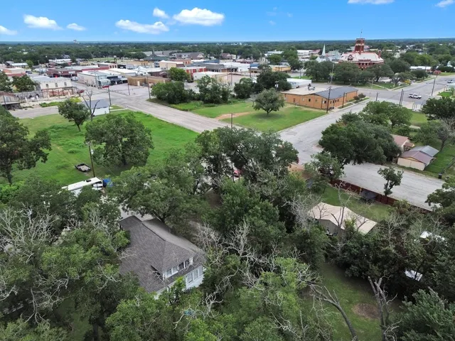 an aerial view of residential houses with outdoor space and river